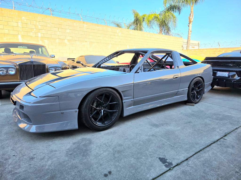MotoIQ S13 racecar interior showing custom battery box and roll cage