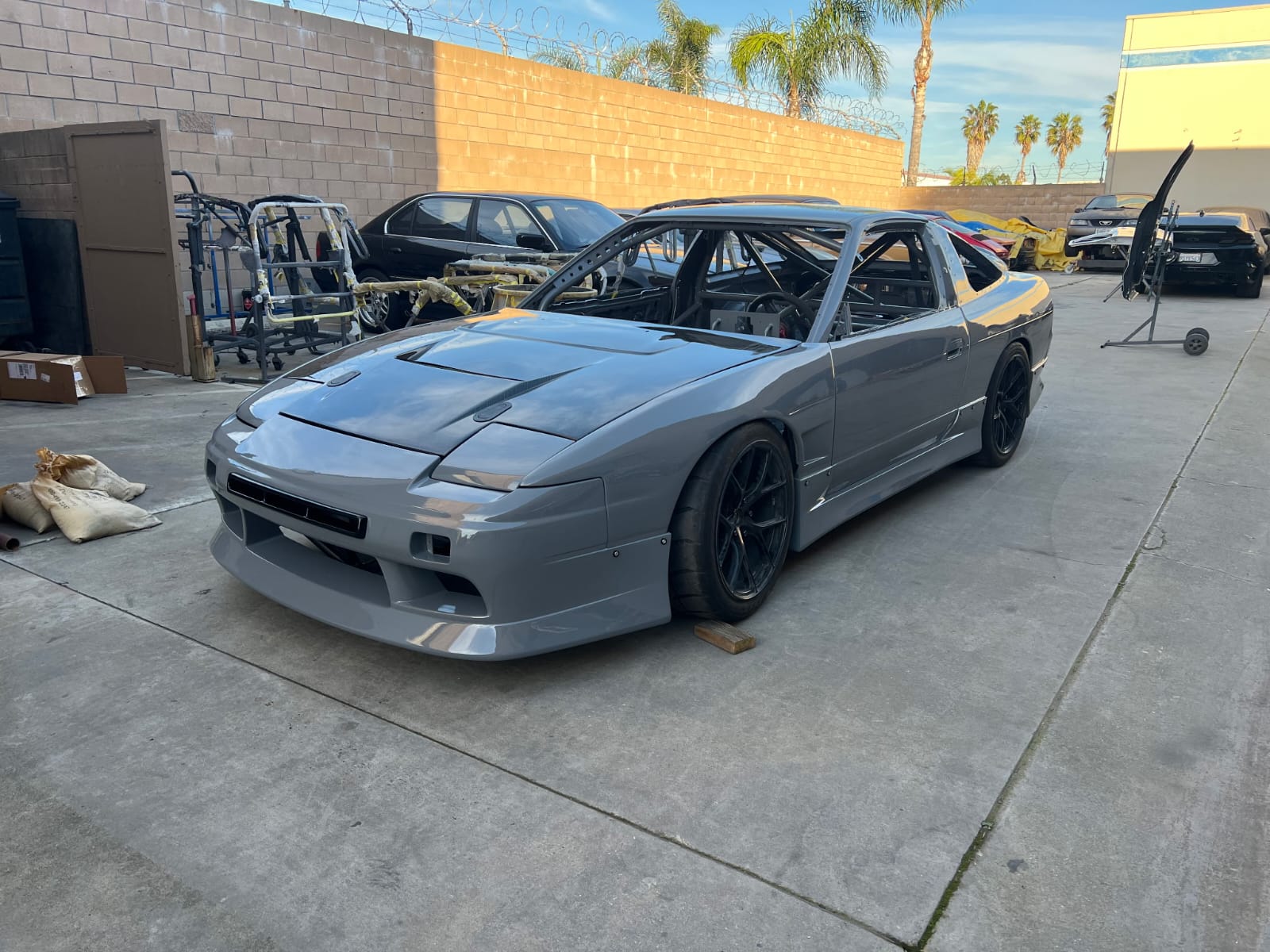 MotoIQ S13 racecar front three-quarter exterior in shop