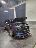 NISMO QX80 R-Spec front three-quarter view in ZSM shop with wide-body kit and bronze wheels
