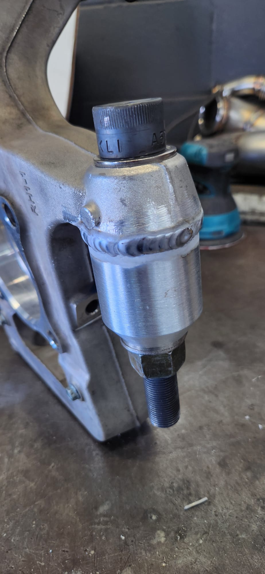 Custom twin turbo system with Garrett turbos and stainless exhaust piping on workbench — angle 1