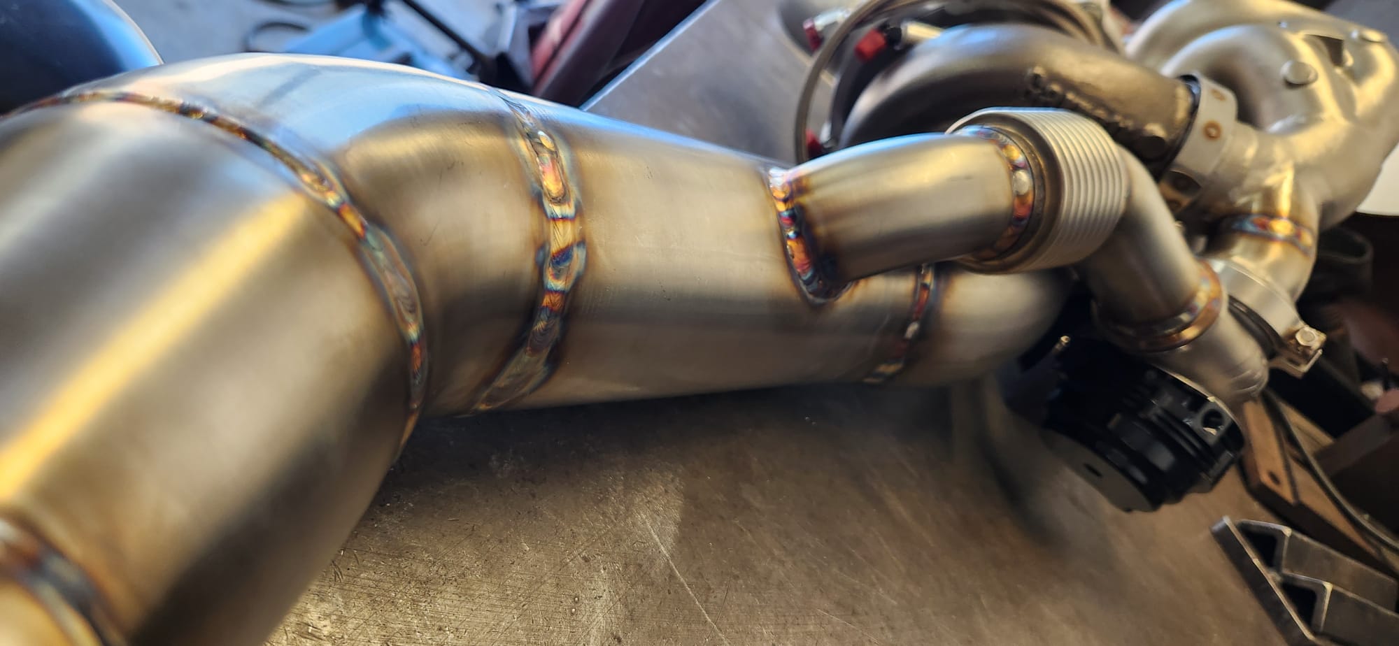 QX80 R-Spec rear bumper at SEMA showing custom dual exhaust tips and R-spec badge