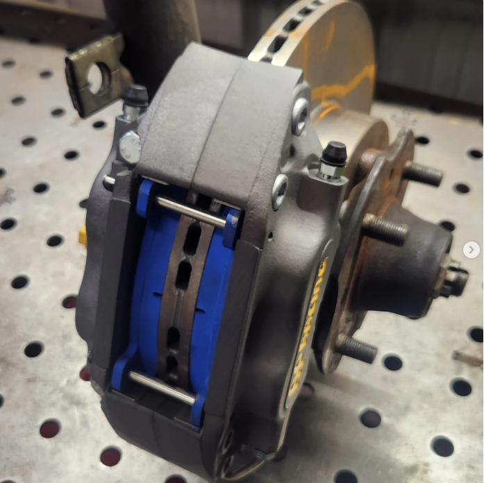 ZSM S30Z AP Racing caliper and bracket installed on front hub assembly on welding table