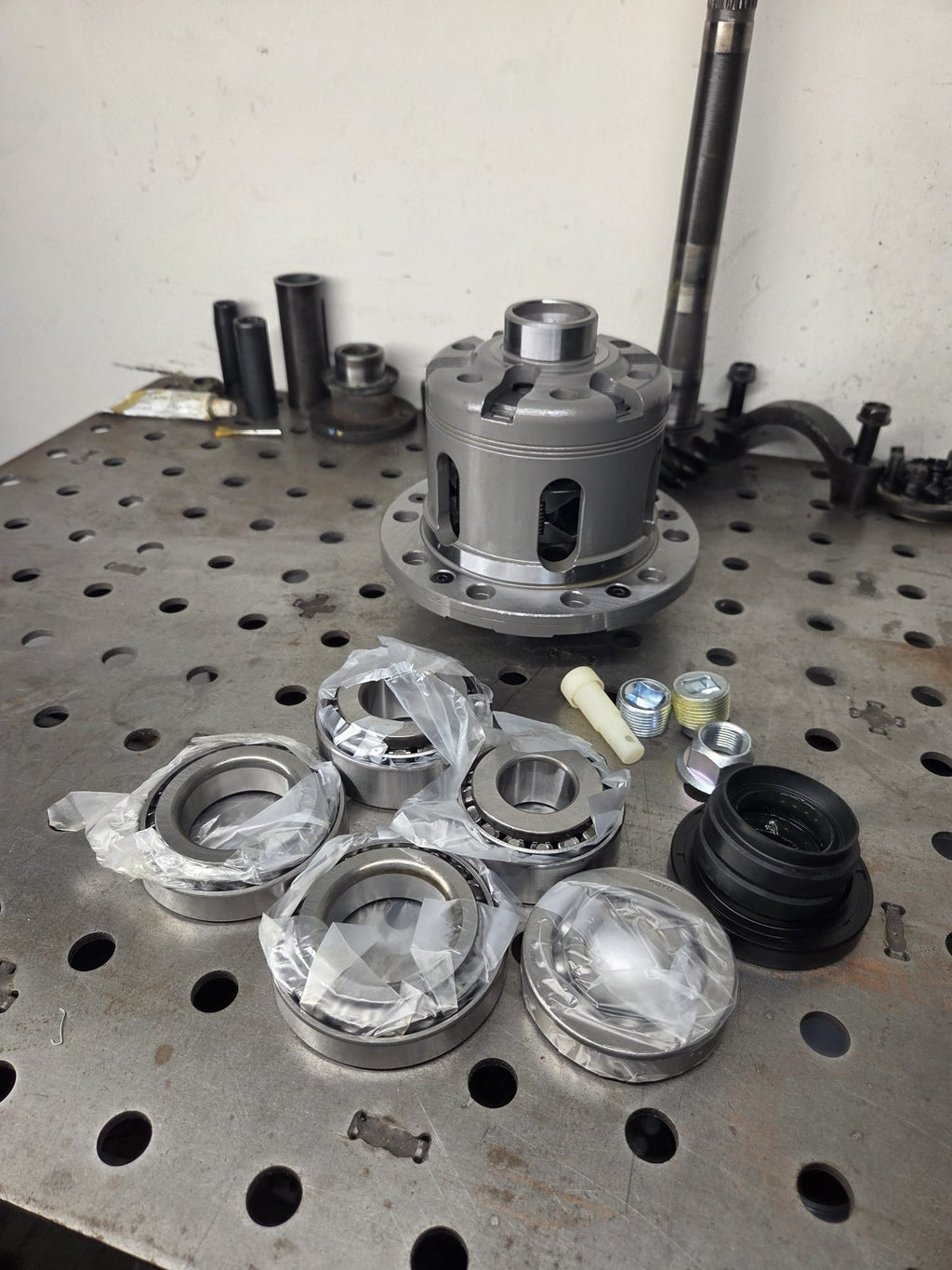 Cusco LSD differential with rebuild bearings and CV boot kit on welding table