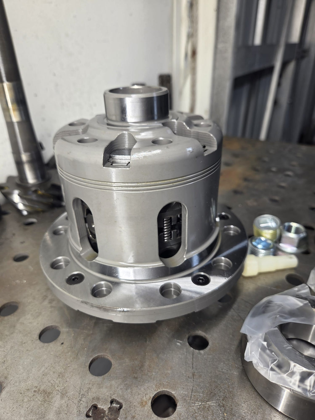 Cusco LSD differential with rebuild kit and axle shafts on welding table