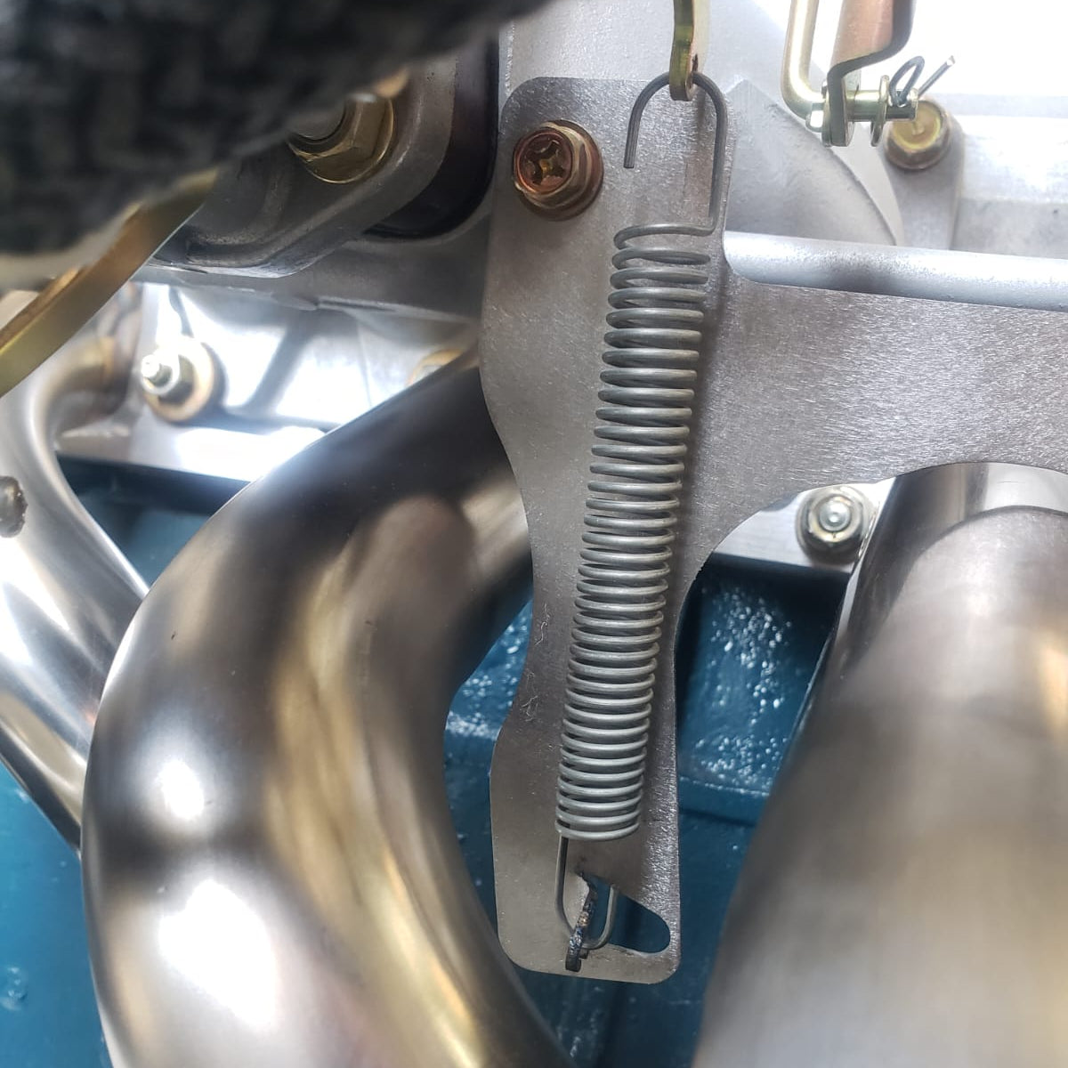 L6 Return Spring Bracket - Mount Under Stock Heatshield