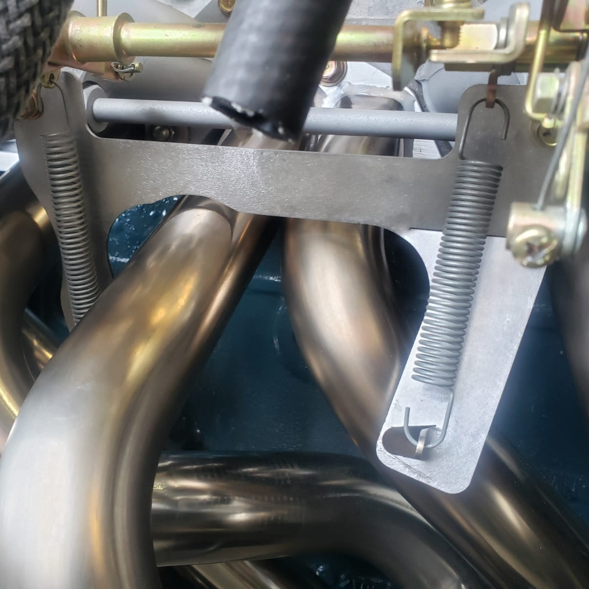 L6 Return Spring Bracket - Mount Under Stock Heatshield